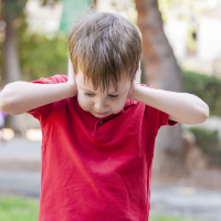 Child plugging his ear